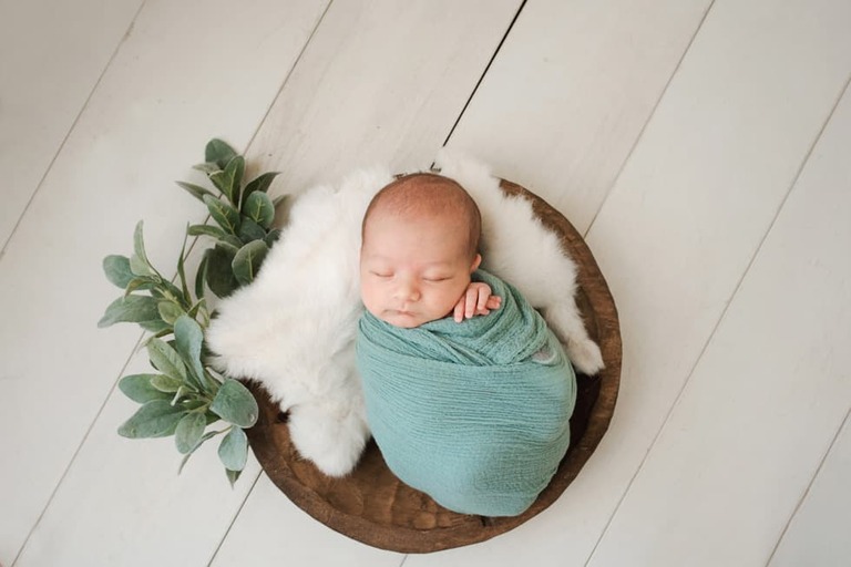 Posing an awake newborn for a successful session