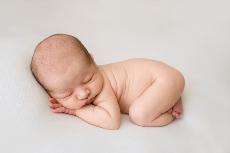 Posing an awake newborn for a successful session