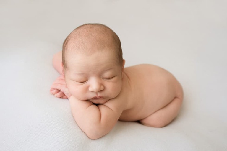 Posing an awake newborn for a successful session