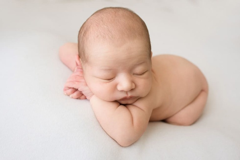 Posing an awake newborn for a successful session