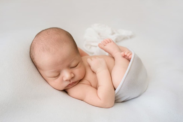 Posing an awake newborn for a successful session