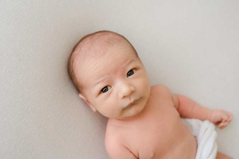 Posing an awake newborn for a successful session