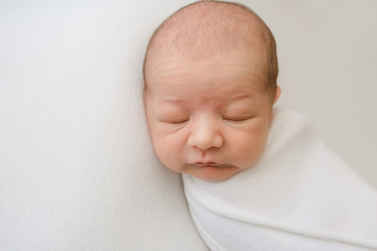 Posing an awake newborn for a successful session