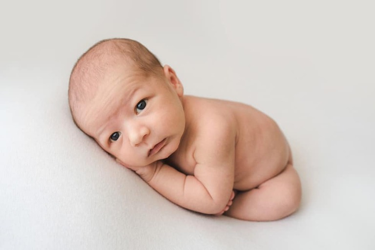 Posing an awake newborn for a successful session