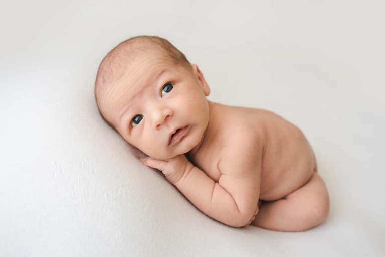 Posing an awake newborn for a successful session