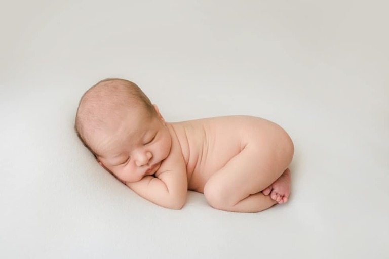 Posing an awake newborn for a successful session