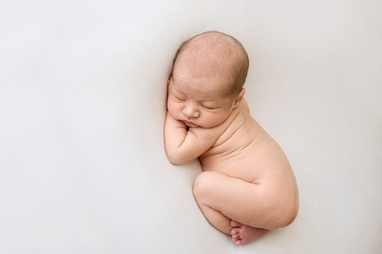 Posing an awake newborn for a successful session