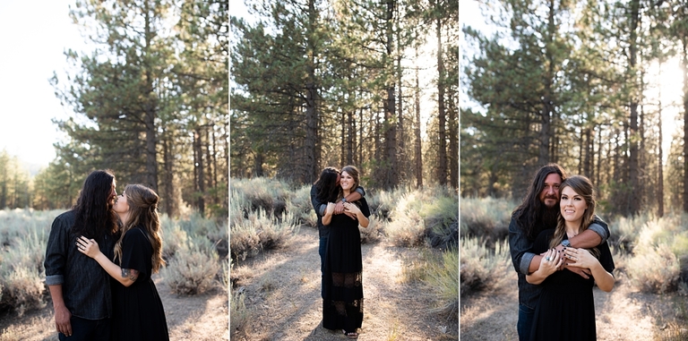 Couple standing in front of forest embracing for engagement photos